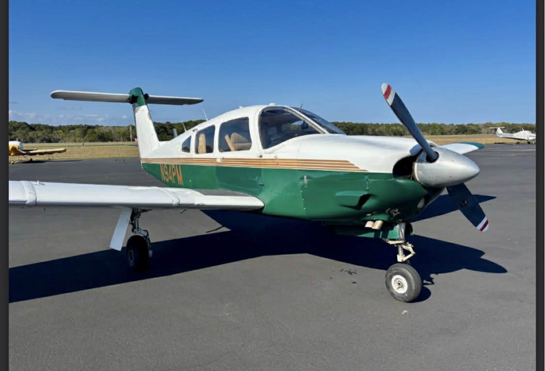 N94PM green and white Piper PA-28 on the ramp